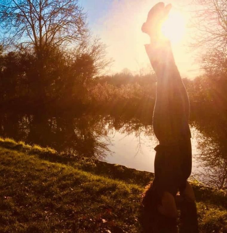 Wild Ripple Competitions | Kate doing a handstand at sunset